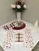 Rose pink snowflake appliance handle covers showcased on a festive kitchen table with decorative elements.