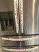 Rose pink snowflake appliance handle covers on a stainless steel refrigerator, adding a festive touch to kitchen decor.