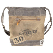 Rustic canvas crossbody bag with adjustable strap, zippered front pocket, and vintage style for outdoor adventures.
