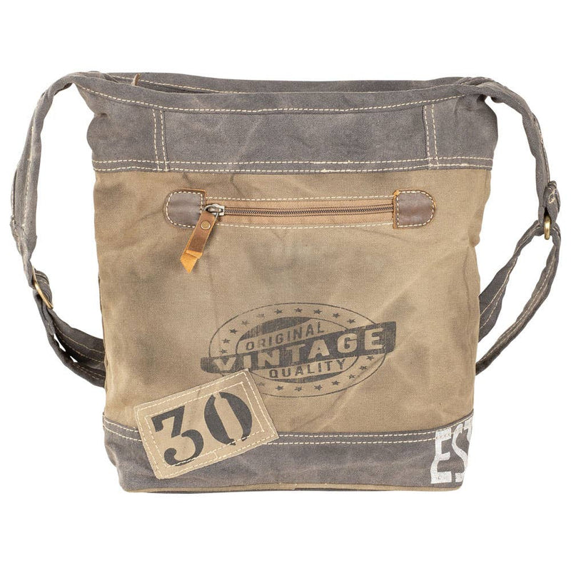Rustic canvas crossbody bag with adjustable strap, zippered front pocket, and vintage style for outdoor adventures.