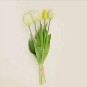 Soft silicone artificial tulip bouquet with white and yellow tulips and green leaves, perfect for home decor and events.