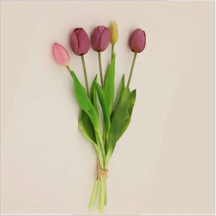 Soft silicone artificial tulip bouquet in pink and purple hues with green leaves, perfect for home decor and events.