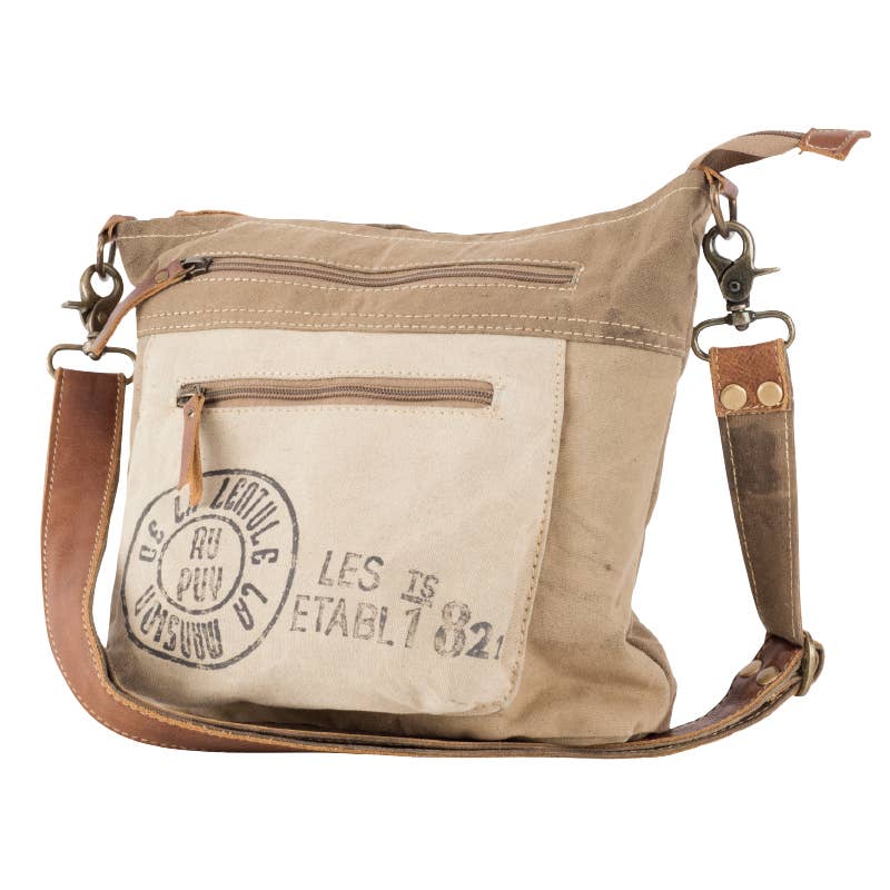 Upcycled canvas shoulder bag in beige with leather straps and functional pockets, perfect for eco-friendly fashion.