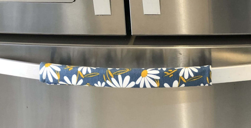 White and Yellow Daisy on Blue Appliance Handle Covers on a refrigerator handle.