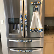 White and Yellow Daisies on Blue Appliance Handle Covers decorating a refrigerator with a matching towel.
