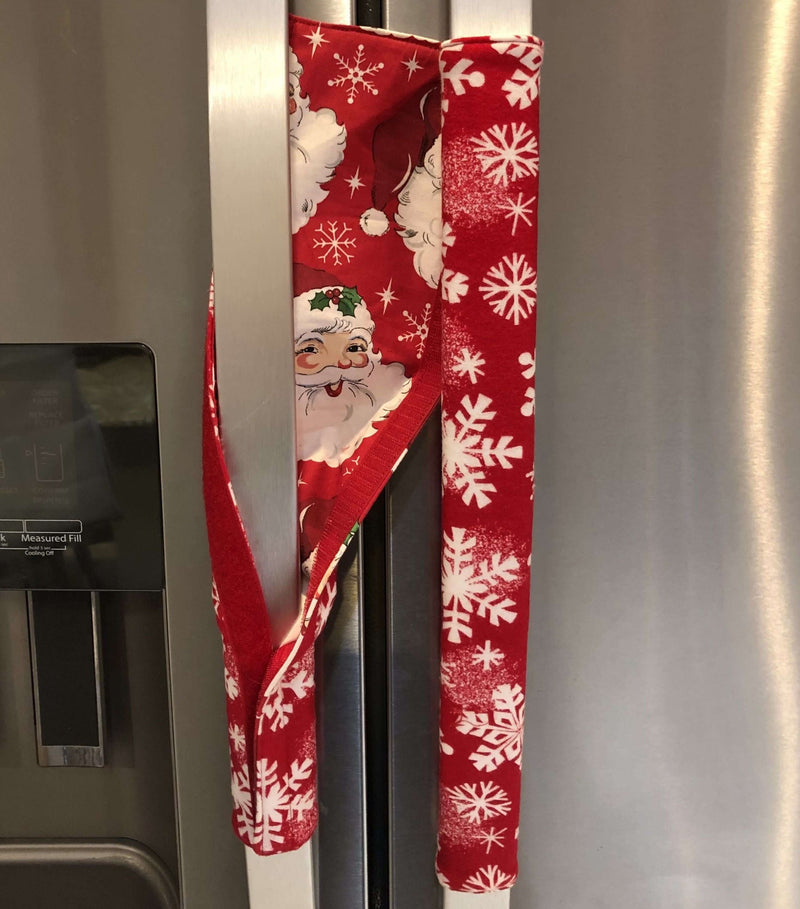 Winter snowflakes appliance handle covers on refrigerator handles, adding festive holiday charm and protection.