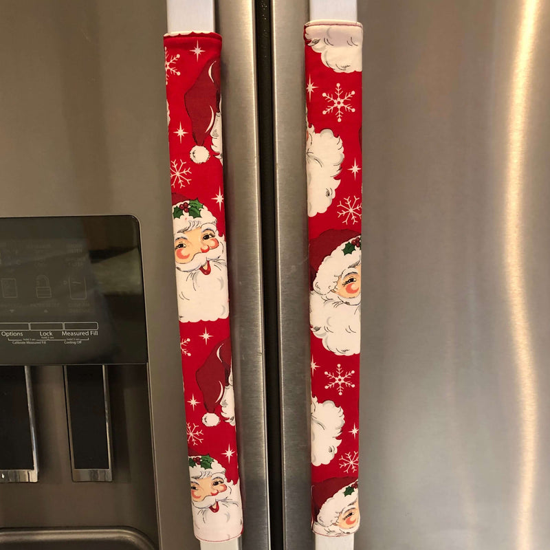 Winter snowflakes appliance handle covers on refrigerator doors with festive Santa design.