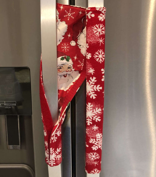 Winter snowflakes appliance handle covers on refrigerator handles, adding festive holiday charm and protection.