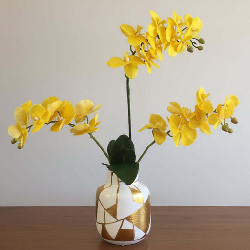 Yellow Real Touch Butterfly Orchid 7 Blooms displayed in a stylish vase, adding elegance and vibrancy to any room.